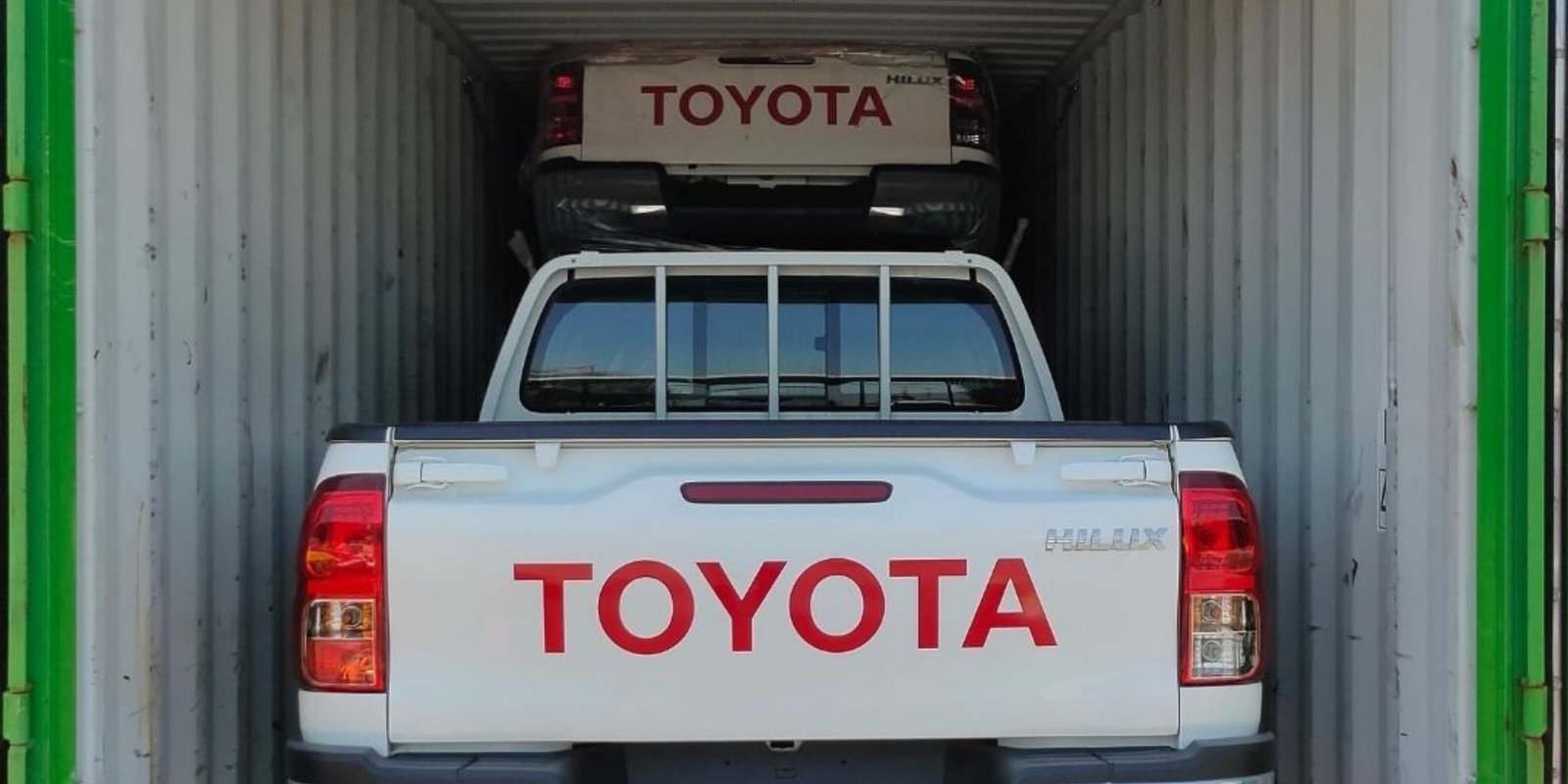 Pickup vehicles loaded inside a shipping container